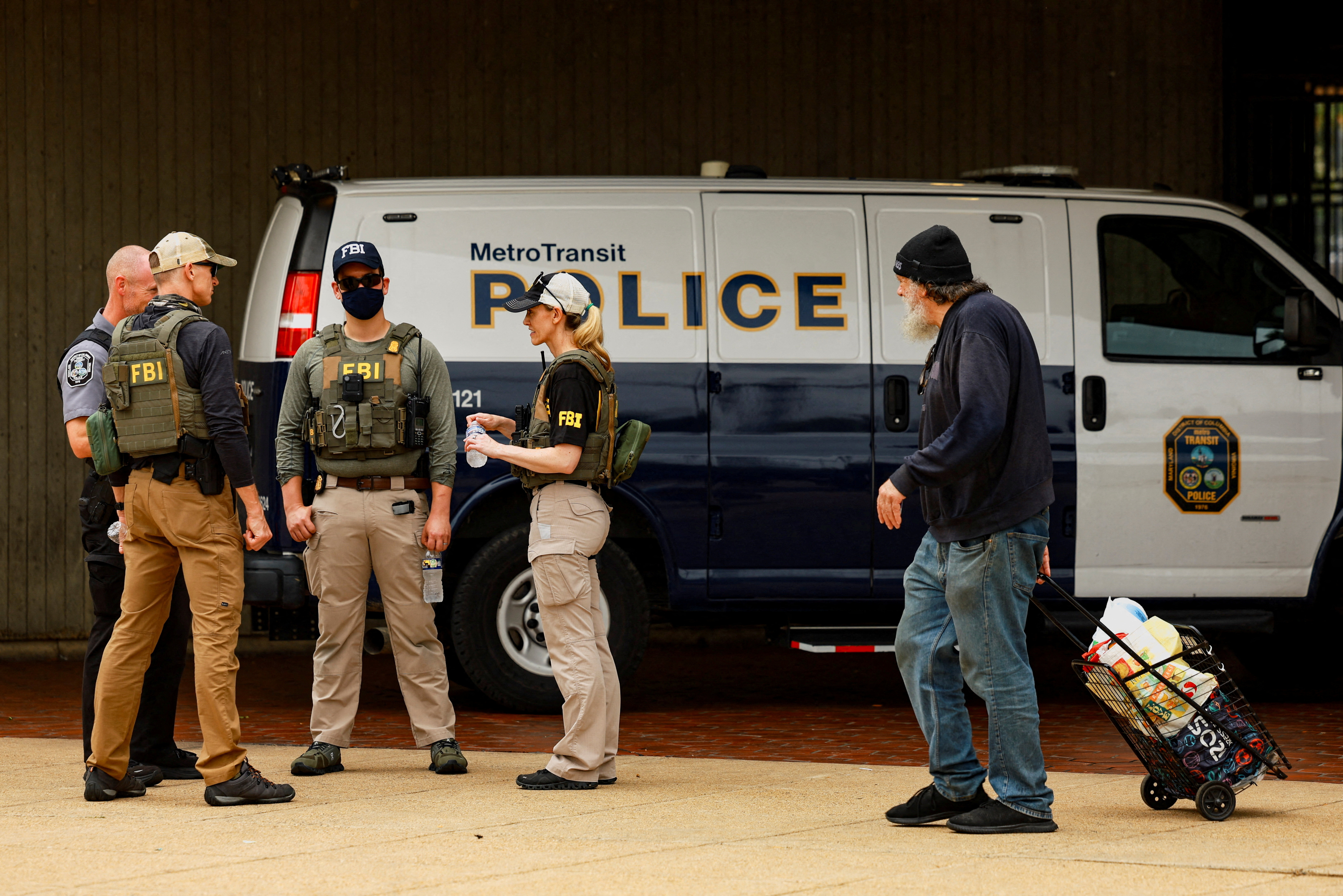 FILE PHOTO: FBI agents gather in front of a Metro Transit Police van near the Anacostia bus station in Washington, D.C.
