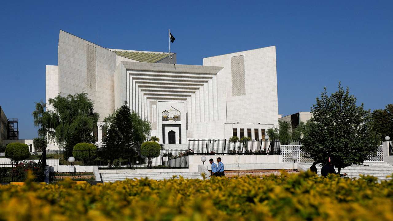 FILE PHOTO: Police officers walk past the Supreme Court of Pakistan building, in Islamabad,