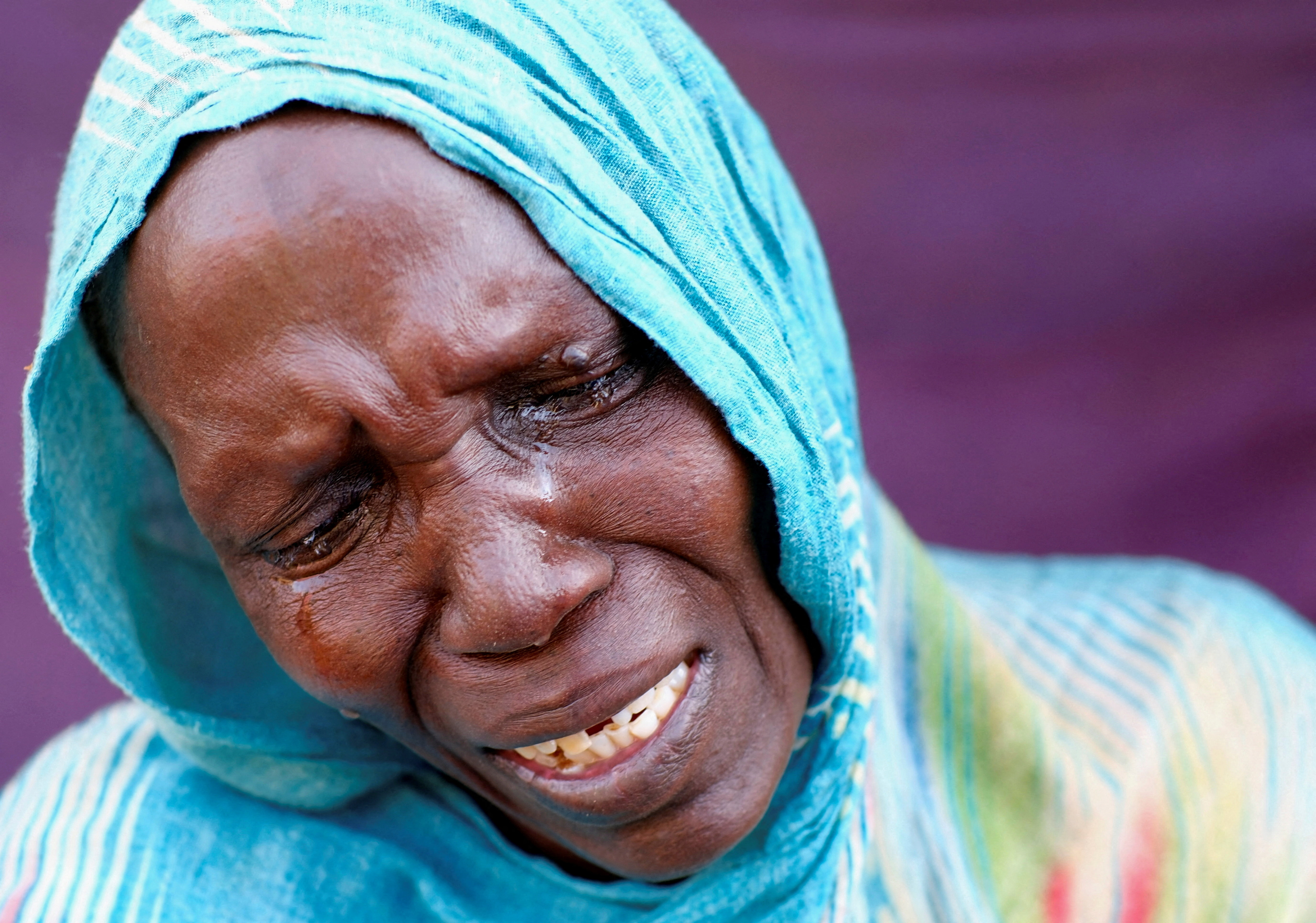 A woman from El Fasher cries after learning about the killing of her son and brother
