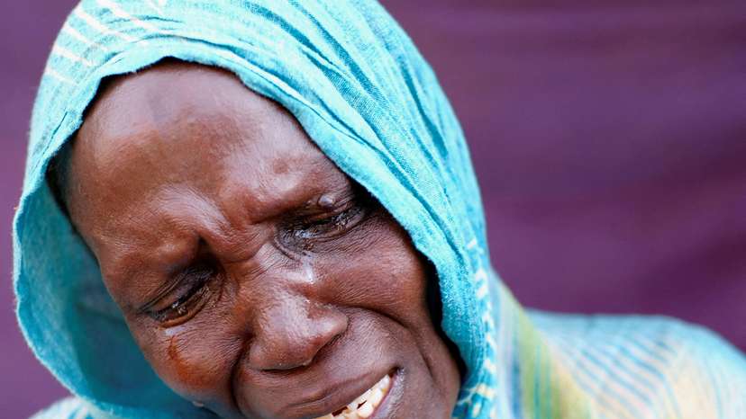 A woman from El Fasher cries after learning about the killing of her son and brother