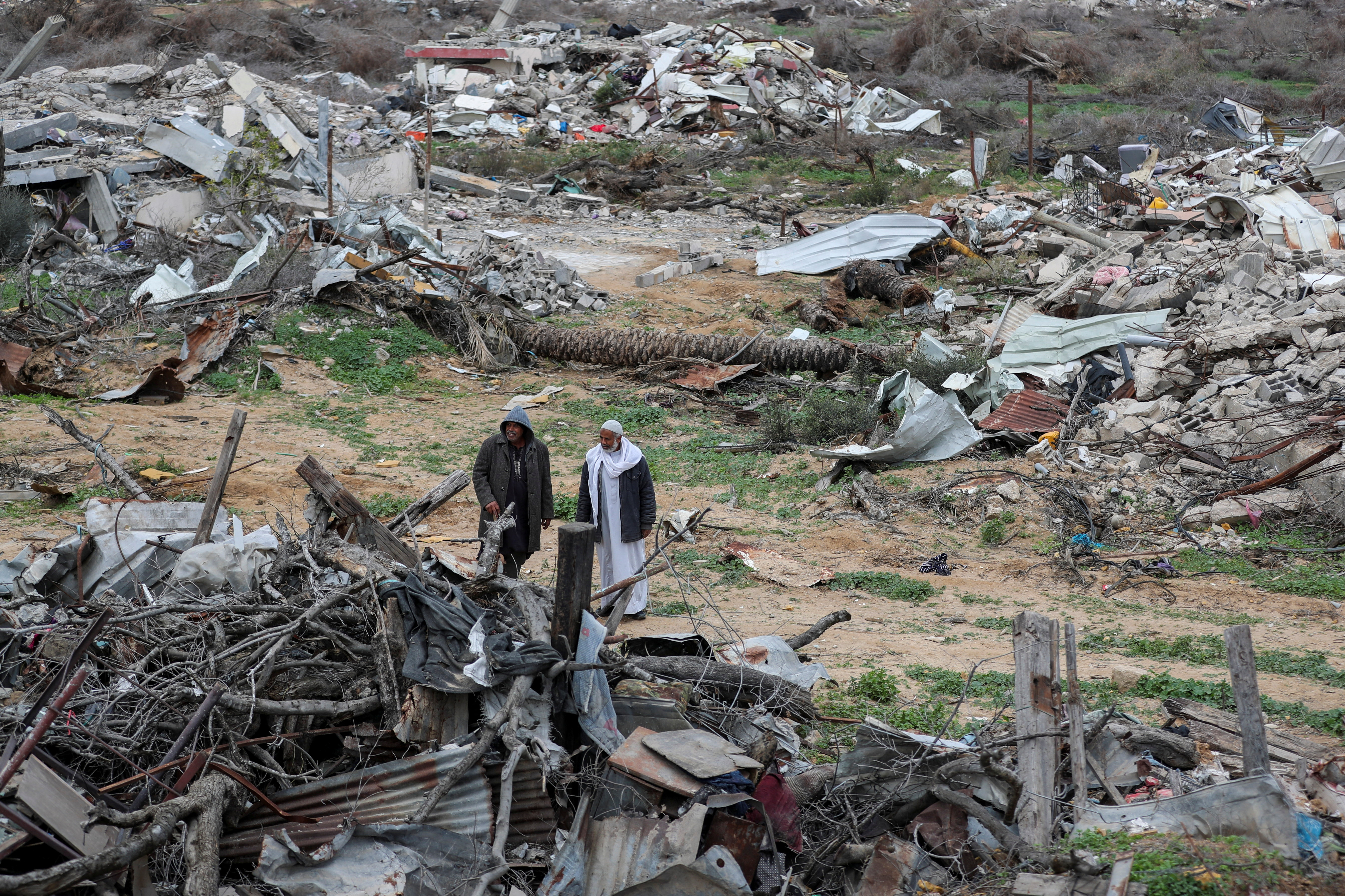 Palestinians view the destruction after Israeli forces withdrew from the Netzarim Corridor, amid a ceasefire between Israel and Hamas, near Gaza City