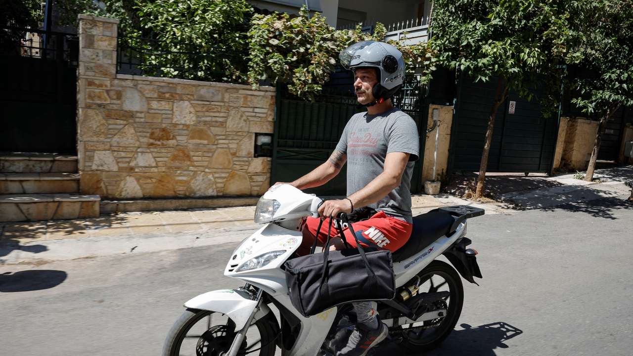 A delivery worker during a heatwave as authorities issue measures for workers
