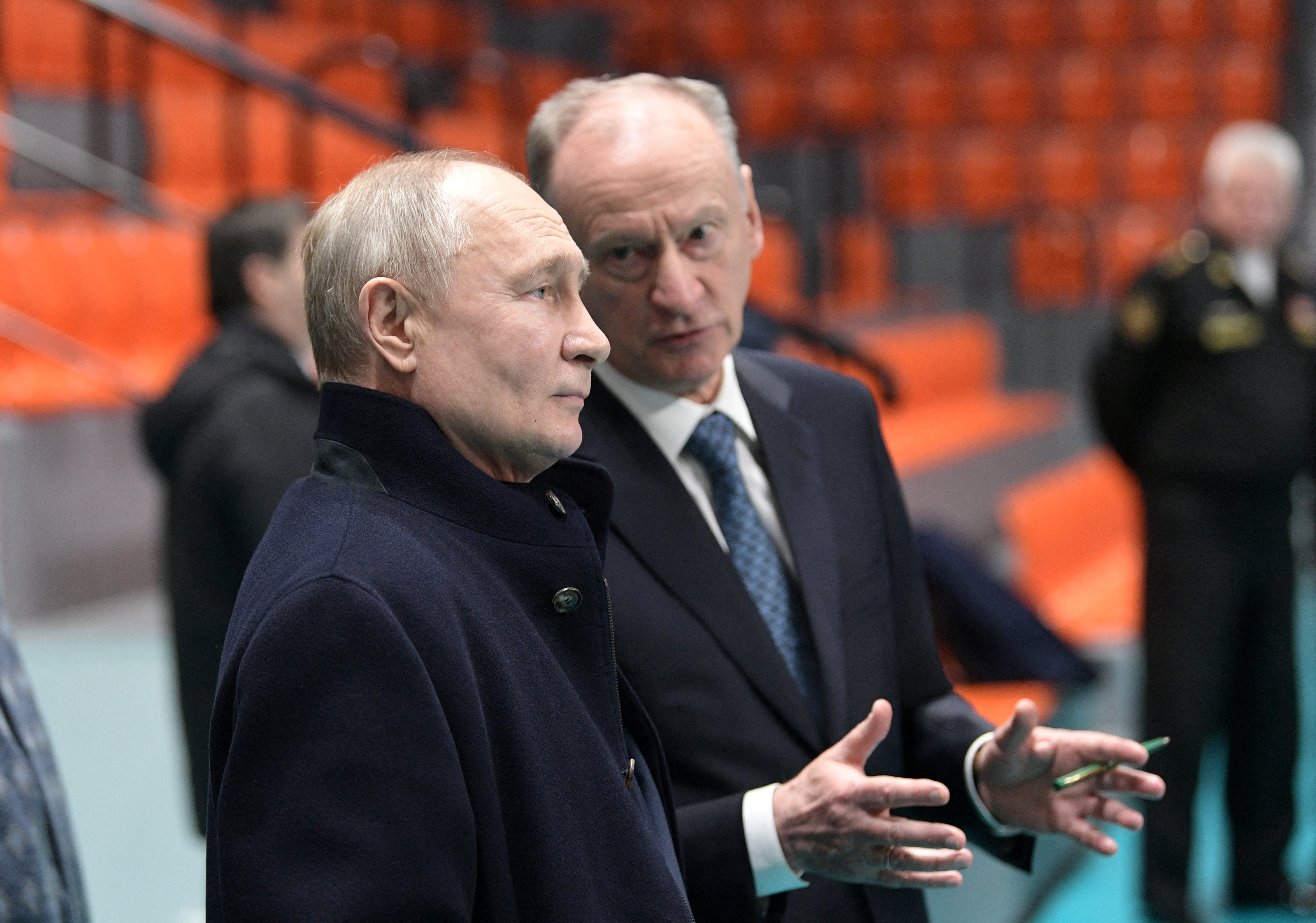 FILE PHOTO: Russian President Vladimir Putin listens to Security Council's Secretary Nikolai Patrushev as they visit a sports hall of the St. Petersburg State Marine Technical University in the city of Saint Petersburg