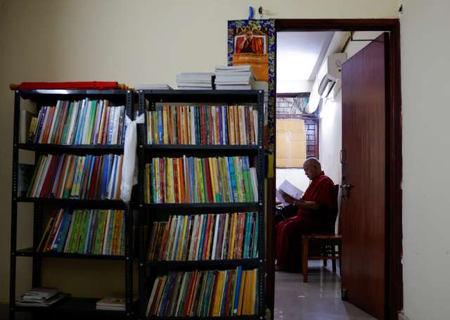 Lama Chosphel Zotpa, a monk and vice president of IHCNBT reads a document at its office in New Delhi