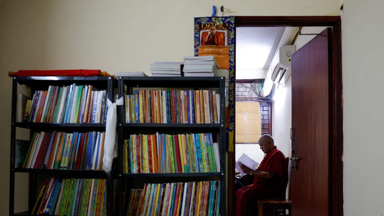 Lama Chosphel Zotpa, a monk and vice president of IHCNBT reads a document at its office in New Delhi