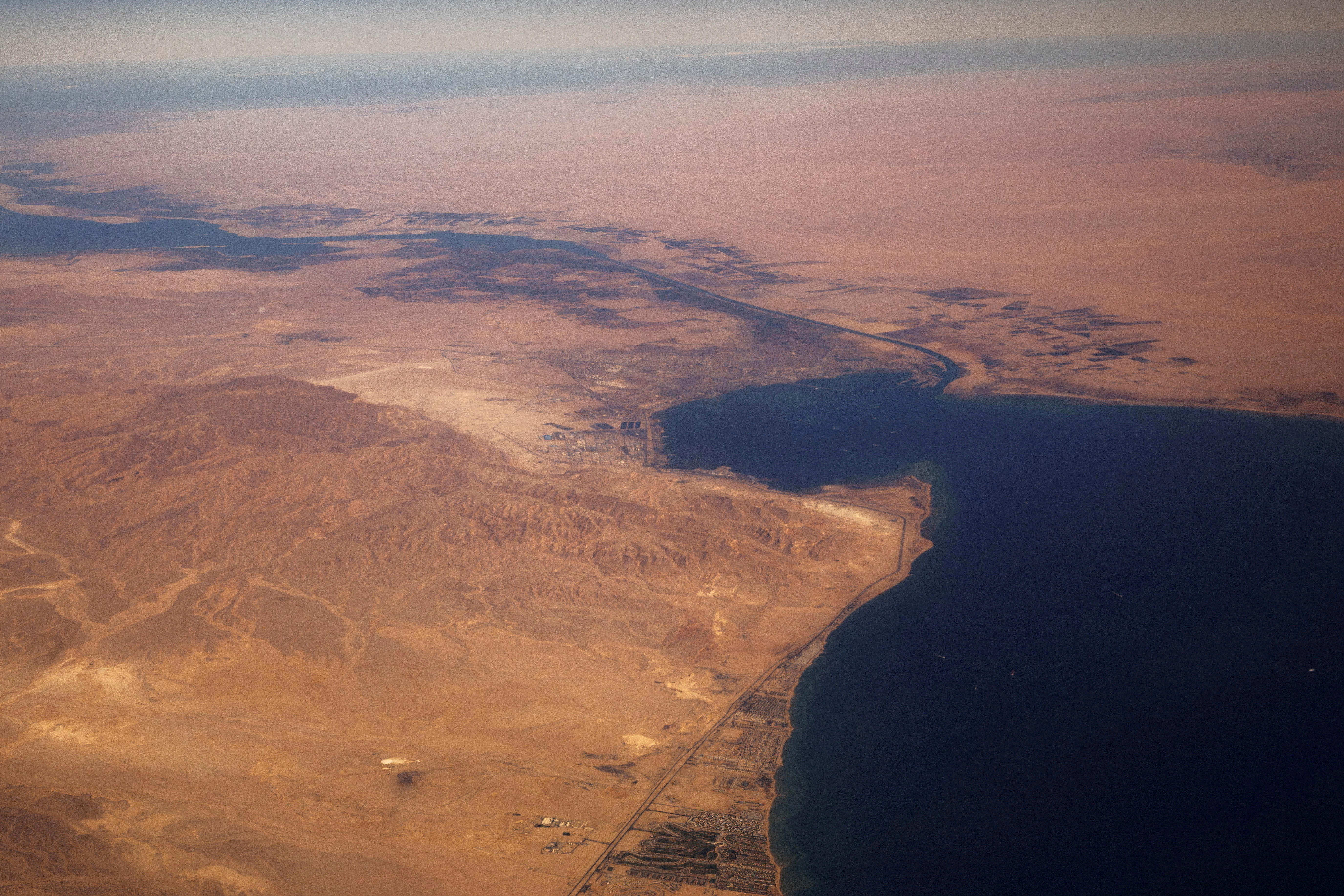 FILE PHOTO: The Suez Canal connecting the Mediterranean Sea to the Red Sea is pictured from the window of a commercial plane flying over Egypt