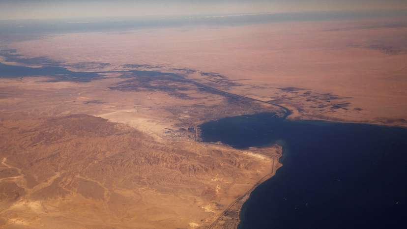 FILE PHOTO: The Suez Canal connecting the Mediterranean Sea to the Red Sea is pictured from the window of a commercial plane flying over Egypt