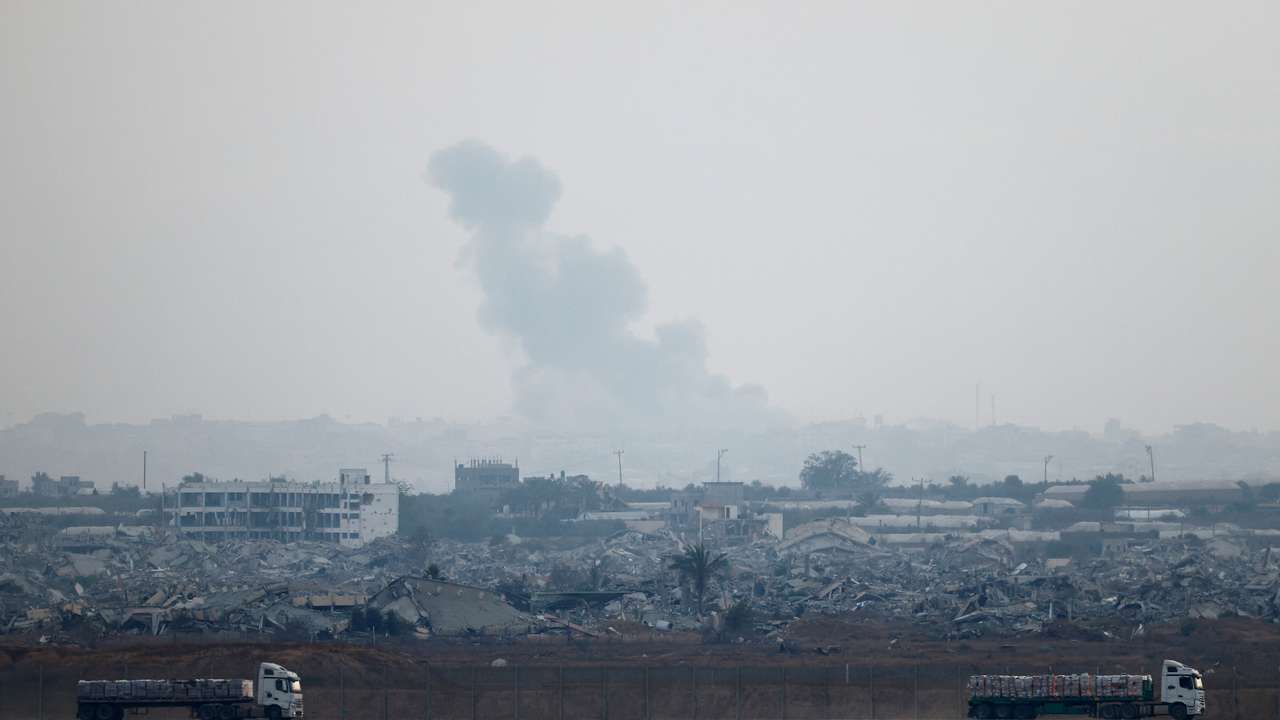 Trucks loaded with aid drive on the Israel-Gaza border as they make their way into Gaza