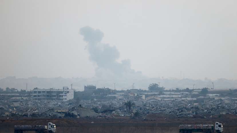 Trucks loaded with aid drive on the Israel-Gaza border as they make their way into Gaza