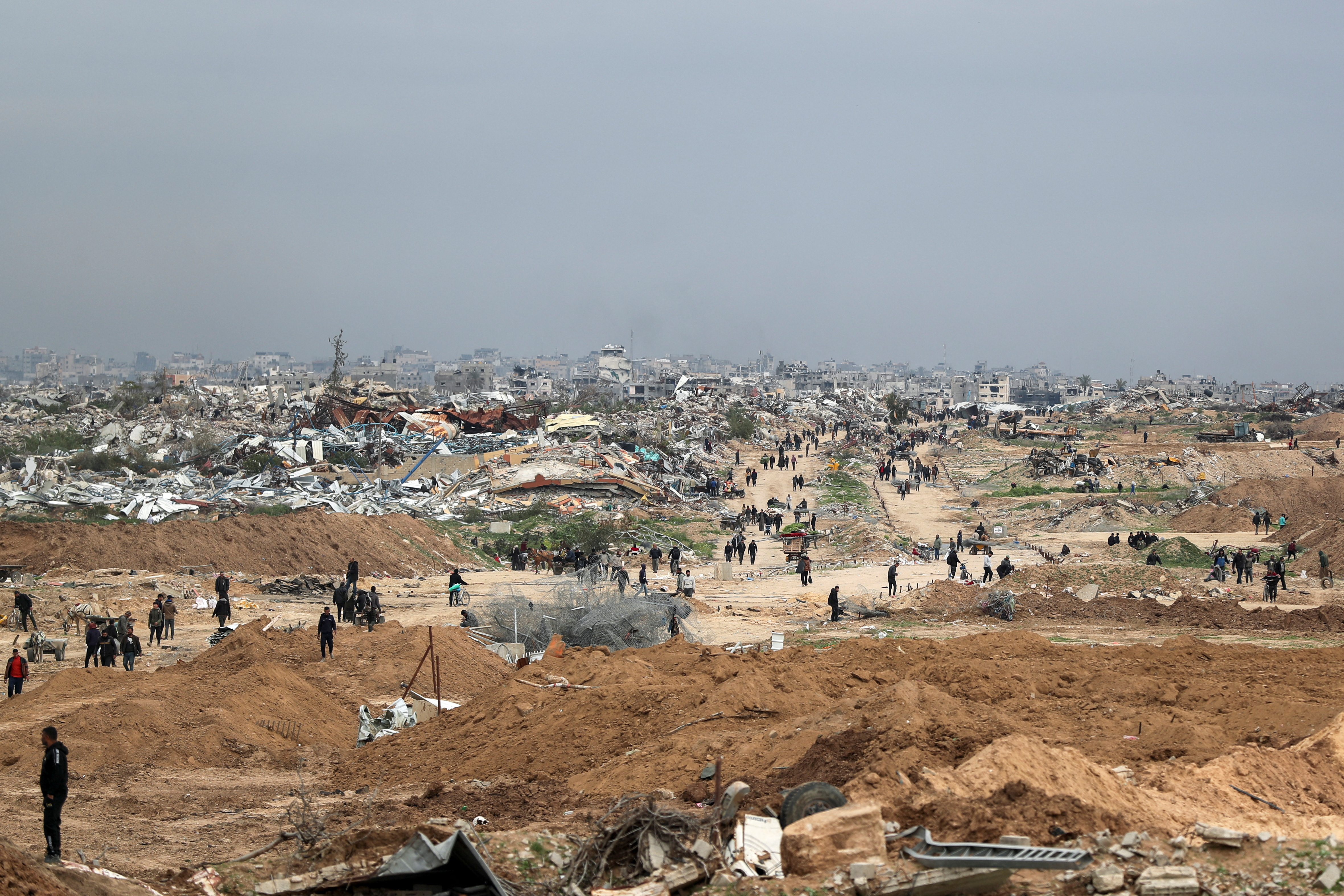 Palestinians make their way after Israeli forces withdrew from the Netzarim Corridor, near Gaza City