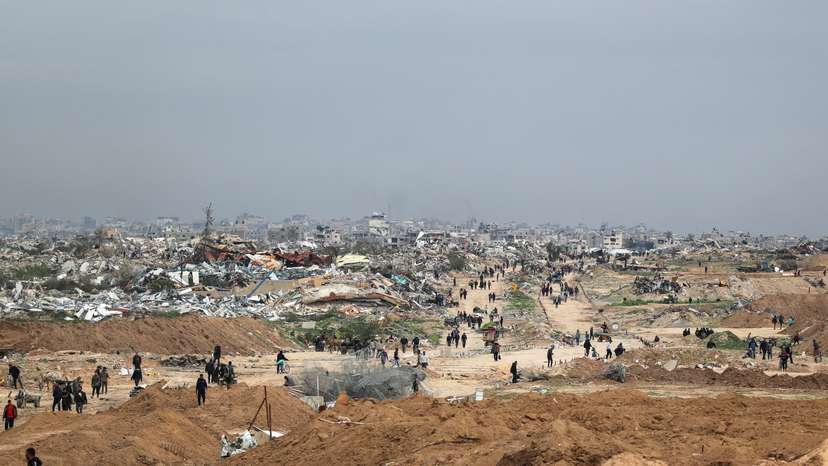 Palestinians make their way after Israeli forces withdrew from the Netzarim Corridor, near Gaza City