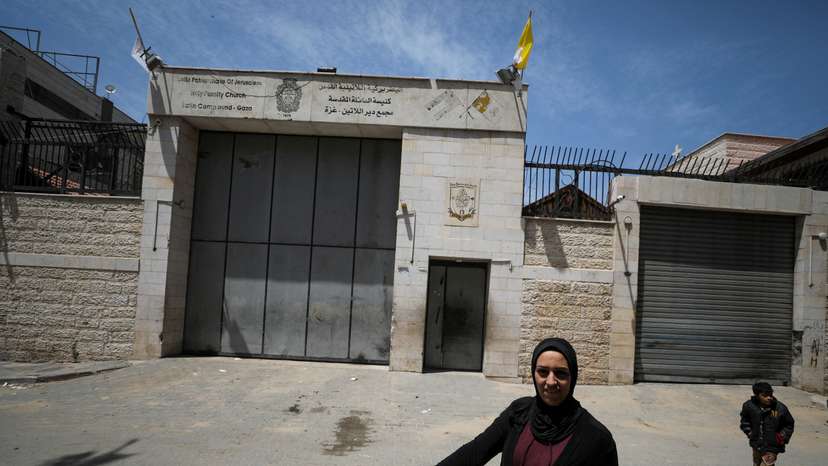 A Palestinian woman walks outside the Holy Family Church after the death of Pope Francis was announced by the Vatican, in Gaza City