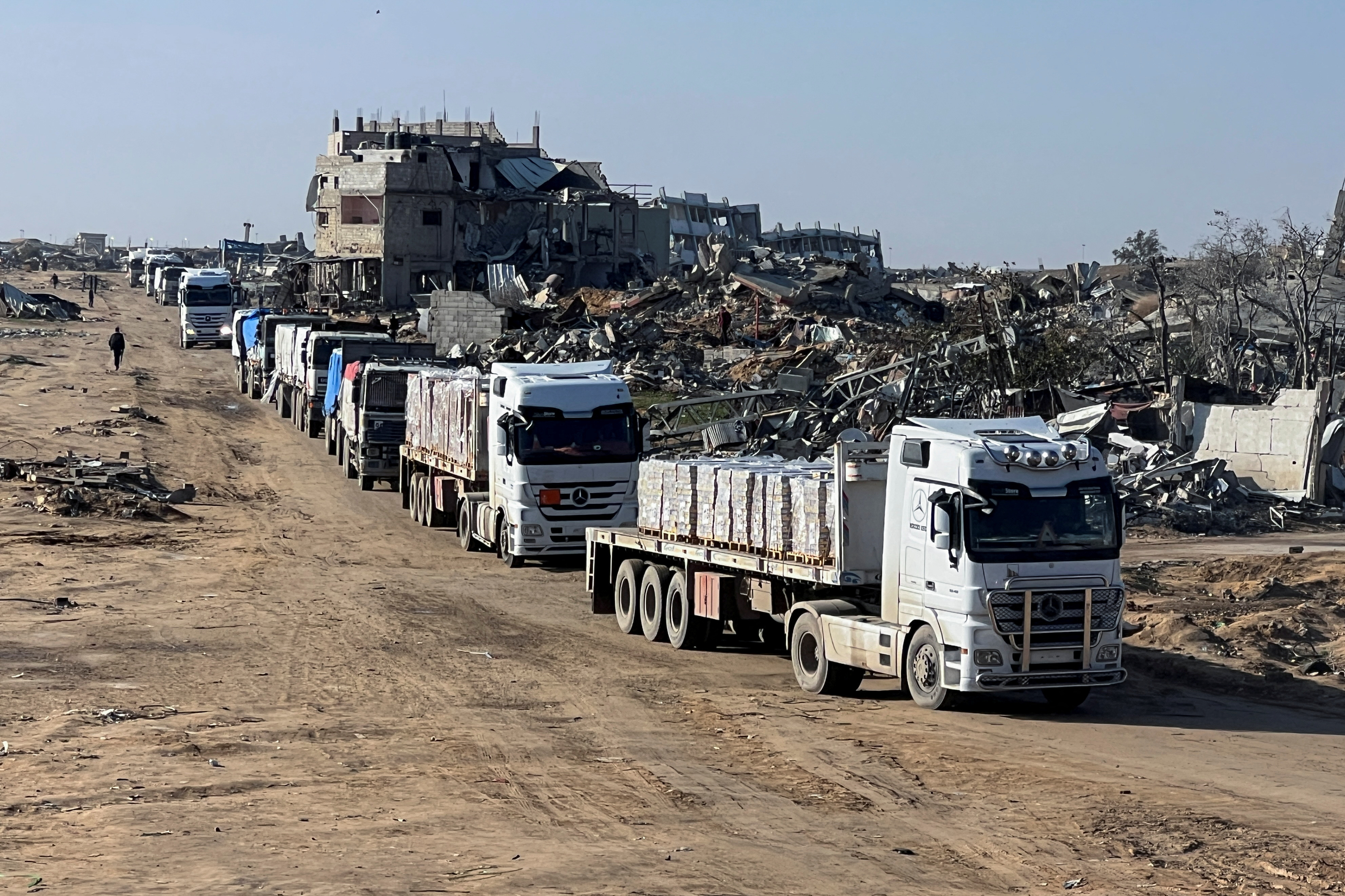 Trucks carrying aid move, amid a ceasefire between Israel and Hamas, in Rafah in the southern Gaza Strip