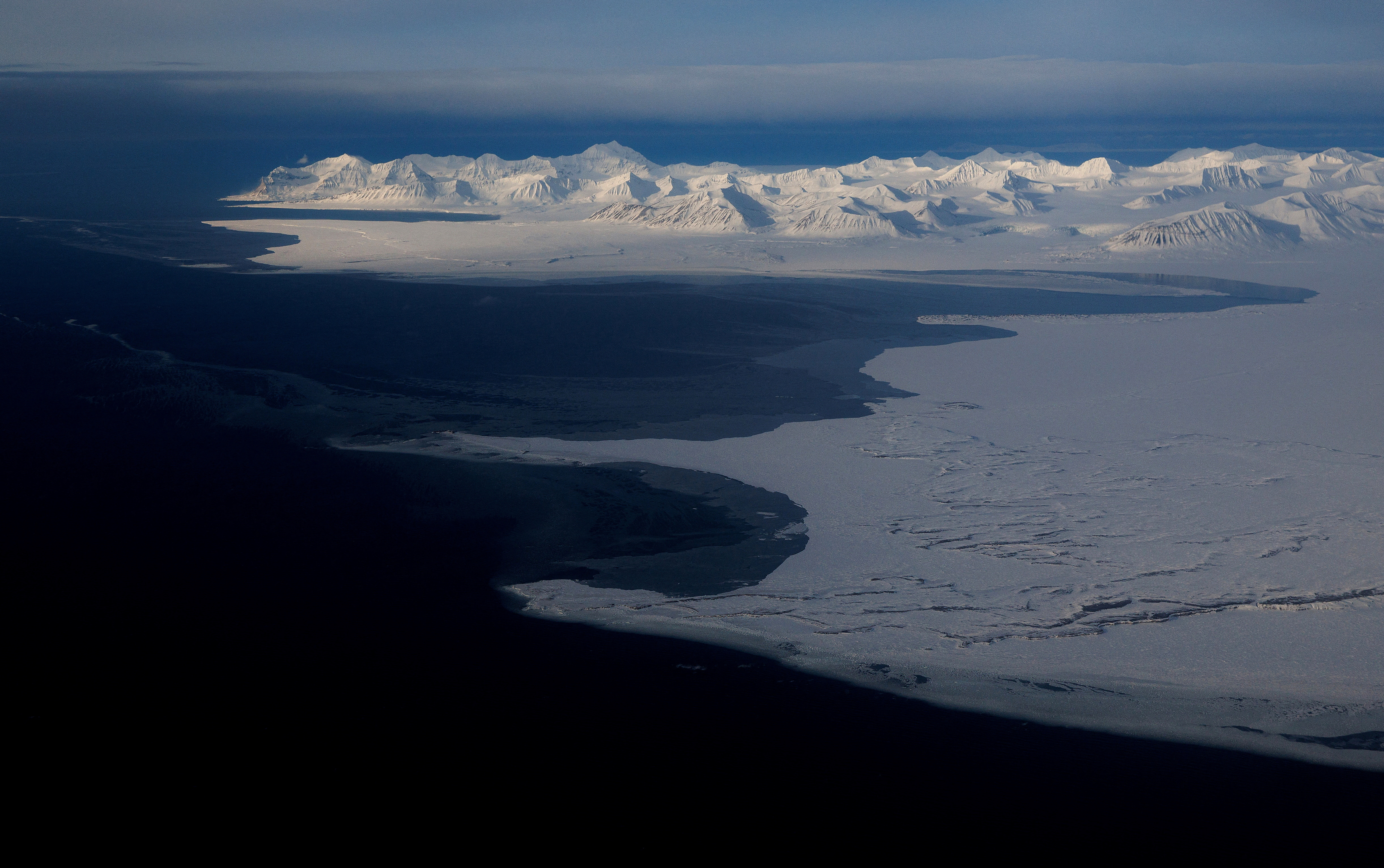 FILE PHOTO: A general view of snowcapped mountains and the Arctic Ocean on the coast of Svalbard near Longyearbyen, Norway,