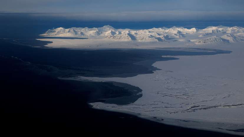FILE PHOTO: A general view of snowcapped mountains and the Arctic Ocean on the coast of Svalbard near Longyearbyen, Norway,