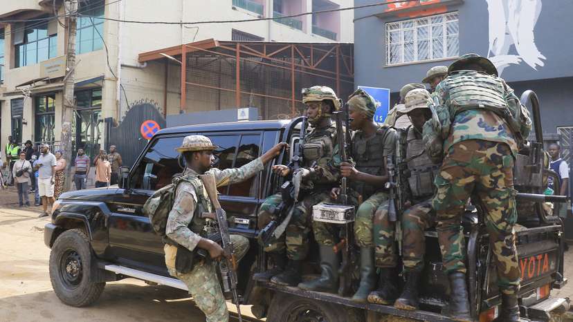 Members of the M23 rebel group gather after recovering guns during a community street cleaning exercise, following the takeover of Bukavu