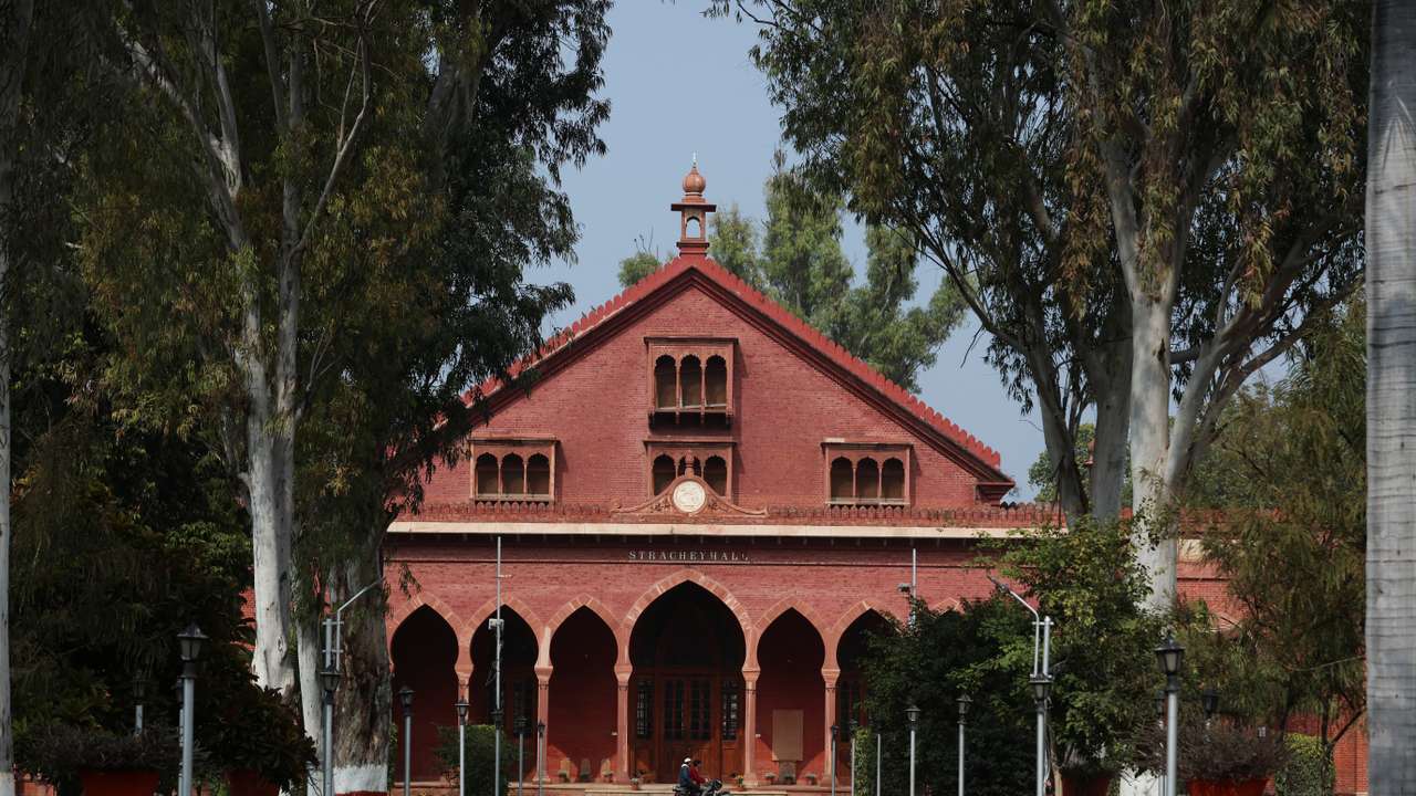 Men ride a motorbike inside the premises of Aligarh Muslim University (AMU) in Aligarh