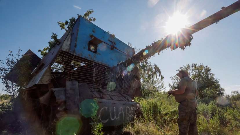 A Ukrainian serviceman appears next to a recently captured Russian T-62 Soviet main battle tank, in Donetsk region