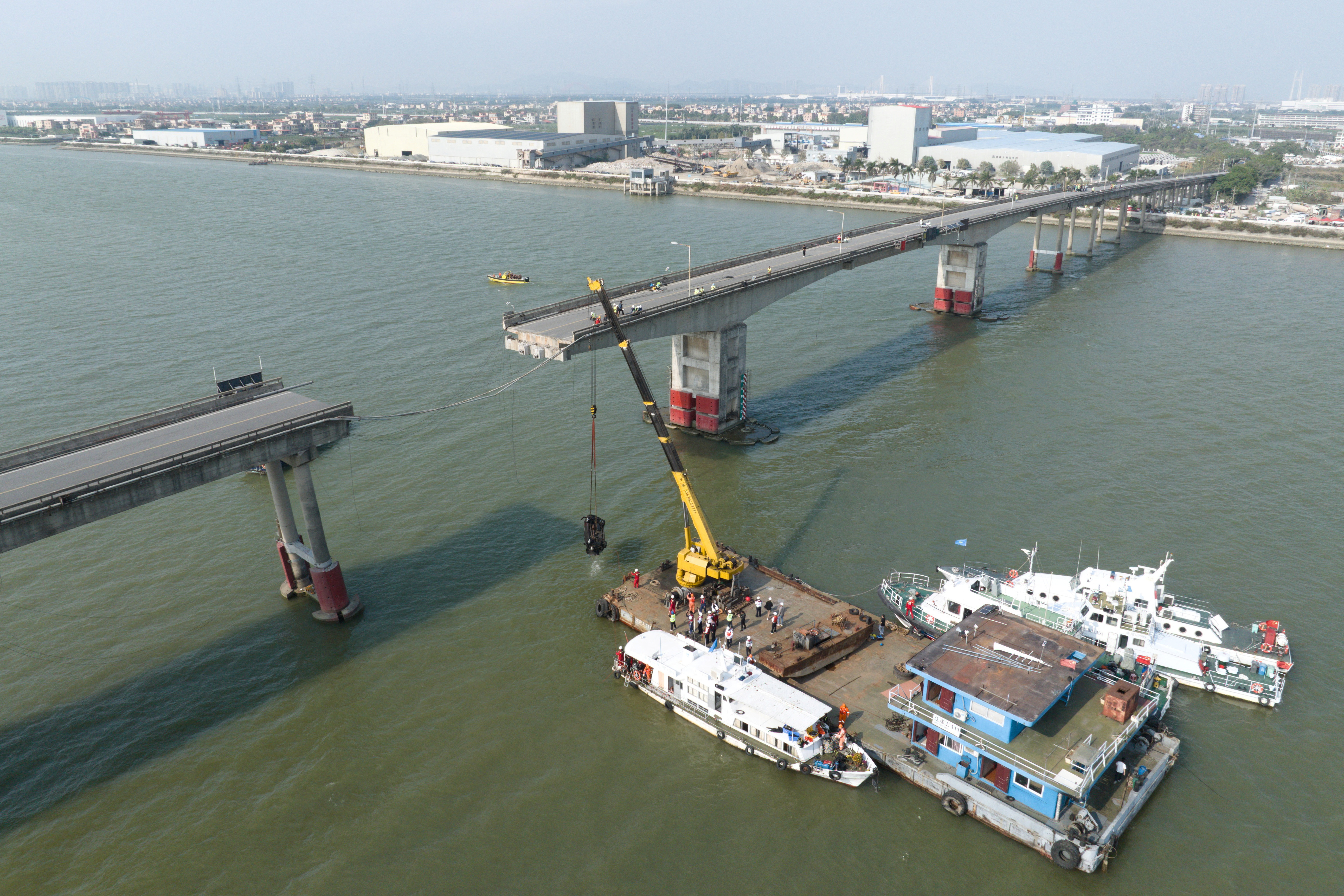Drone view shows rescue workers at the site where a container ship hit Lixinsha bridge in Guangzhou