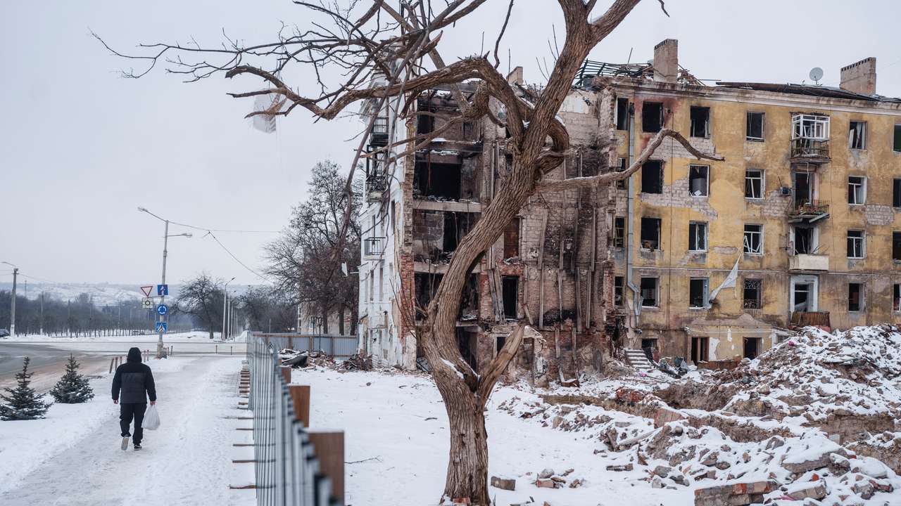 Resident walks next to apartment building hit by a Russian military strike in Kramatorsk, in Kramatorsk