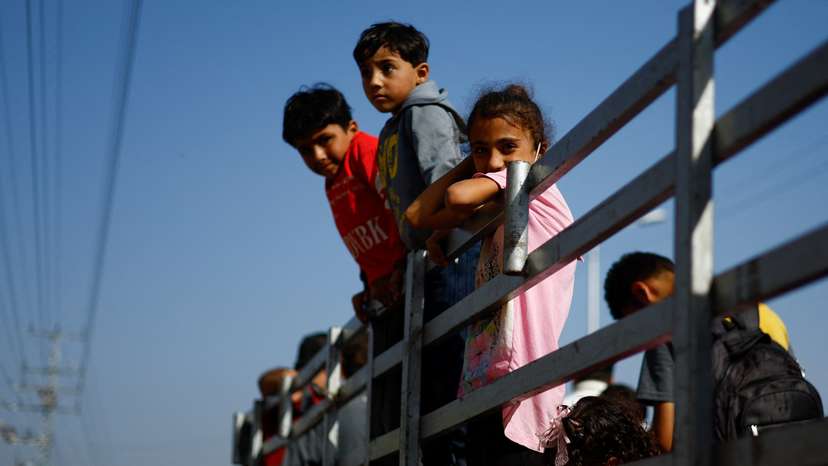 Palestinians flee north Gaza towards the south, amid the ongoing conflict between Israel and Palestinian Islamist group Hamas, in the central Gaza Strip