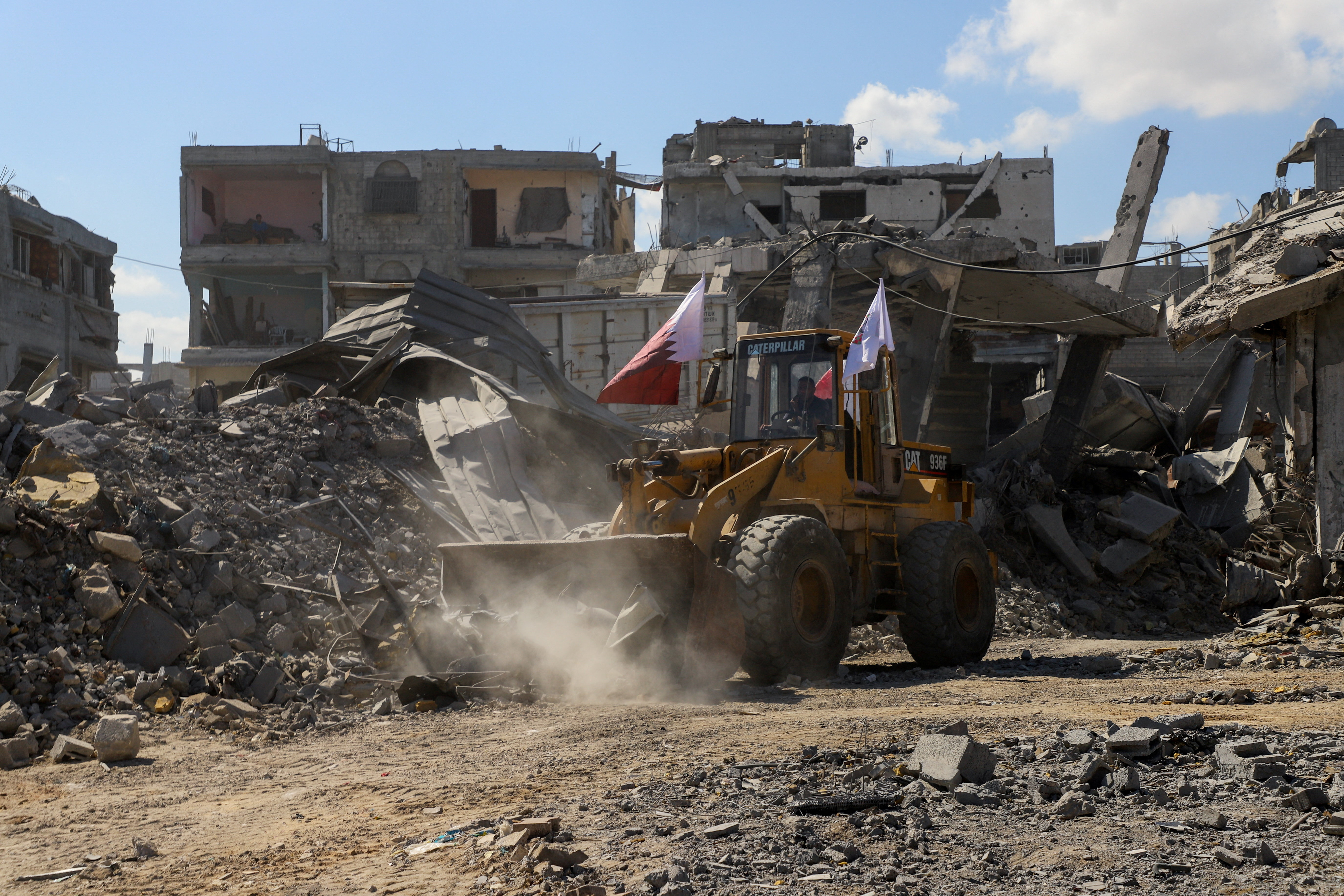 Heavy machinery removes debris from a street, amid a ceasefire between Israel and Hamas, in Gaza City