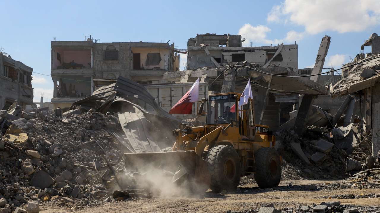 Heavy machinery removes debris from a street, amid a ceasefire between Israel and Hamas, in Gaza City