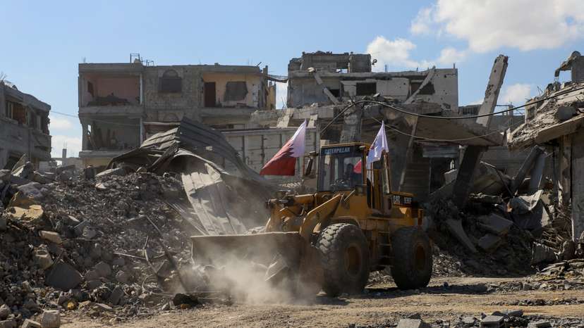 Heavy machinery removes debris from a street, amid a ceasefire between Israel and Hamas, in Gaza City