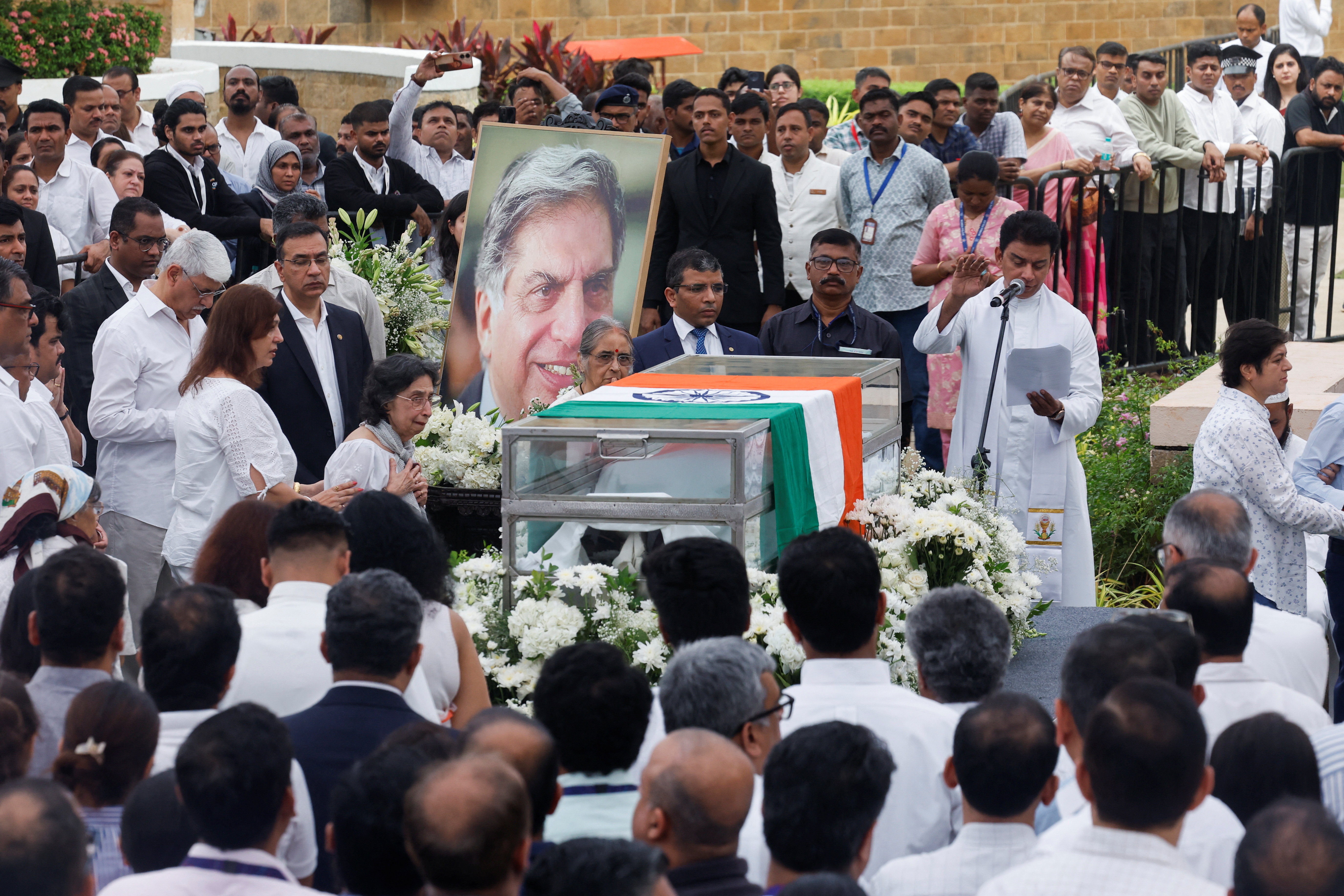 A priest prays during a final viewing for the public to pay their respects to the former chairman of Tata Group Ratan Tata, in Mumbai