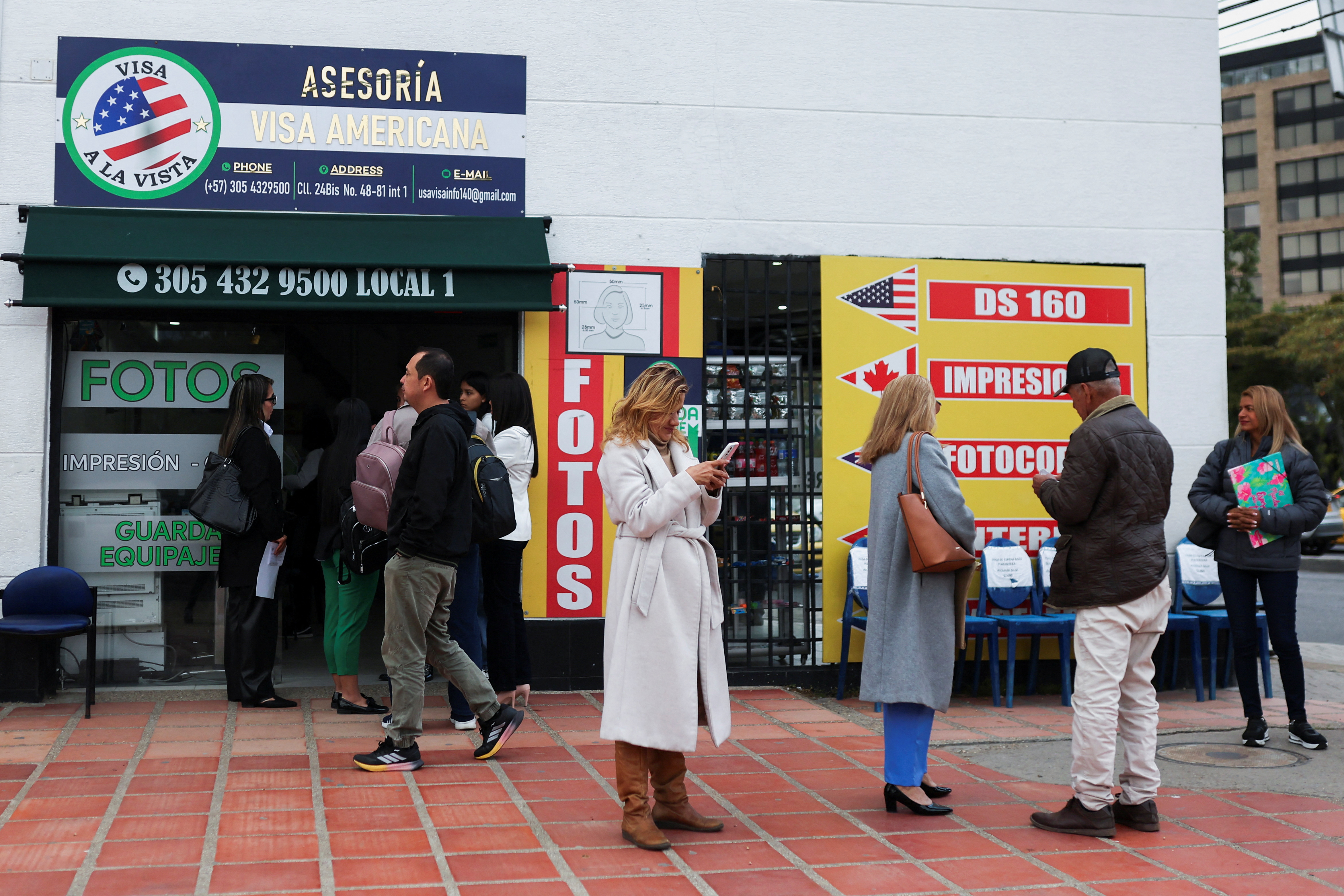 People who had an appointment scheduled for the visa process to the United States and were cancelled, wait outside the United States embassy, in Bogota