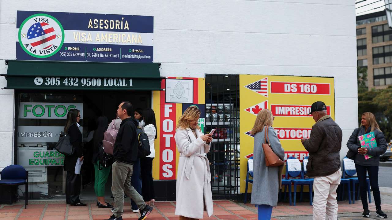 People who had an appointment scheduled for the visa process to the United States and were cancelled, wait outside the United States embassy, in Bogota