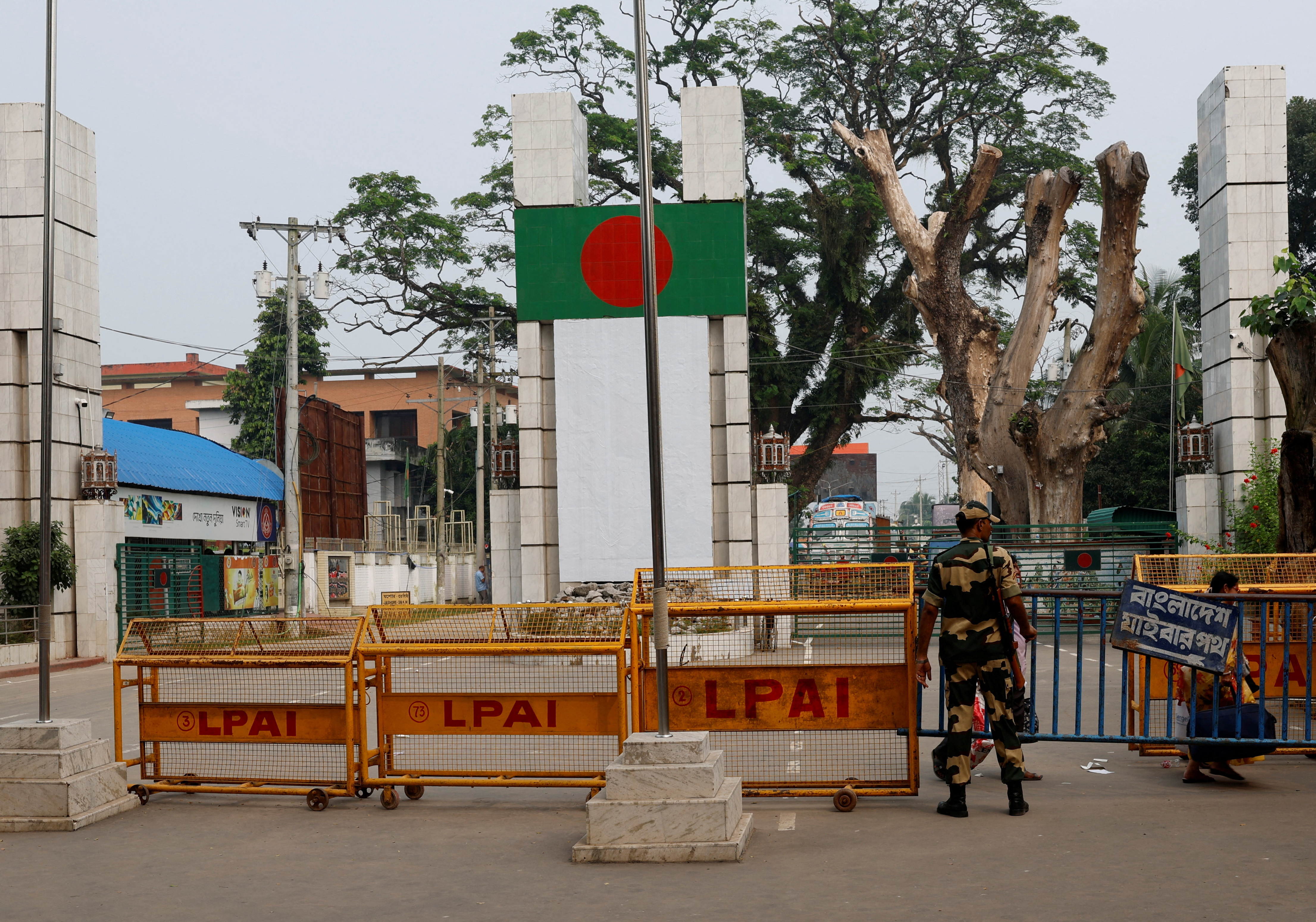 FILE PHOTO: A BSF official stands in front of the gates of the India-Bangladesh international border in Petrapole