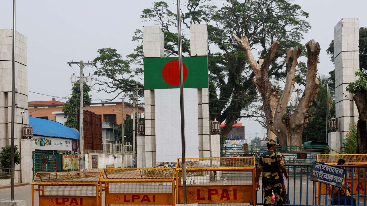 FILE PHOTO: A BSF official stands in front of the gates of the India-Bangladesh international border in Petrapole