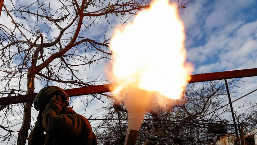 Members of Ukraine's National Guard Omega Special Purpose unit fire a mortar toward Russian troops in the front line town of Avdiivka