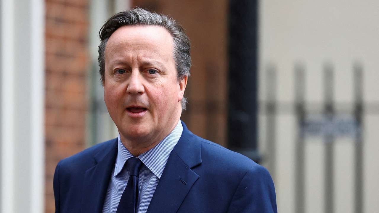 FILE PHOTO: British Foreign Secretary David Cameron walks at Downing Street in London