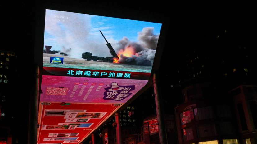 Screen showing a news report on China's military drills around Taiwan, in Beijing