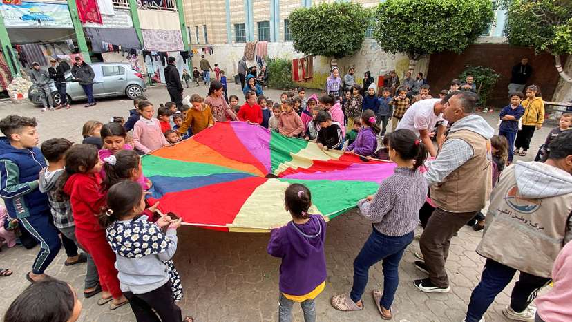 FILE PHOTO: Displaced Palestinians participate in activity organized by volunteers to entertain and support mental health of children affected by the conflict, in Khan Younis