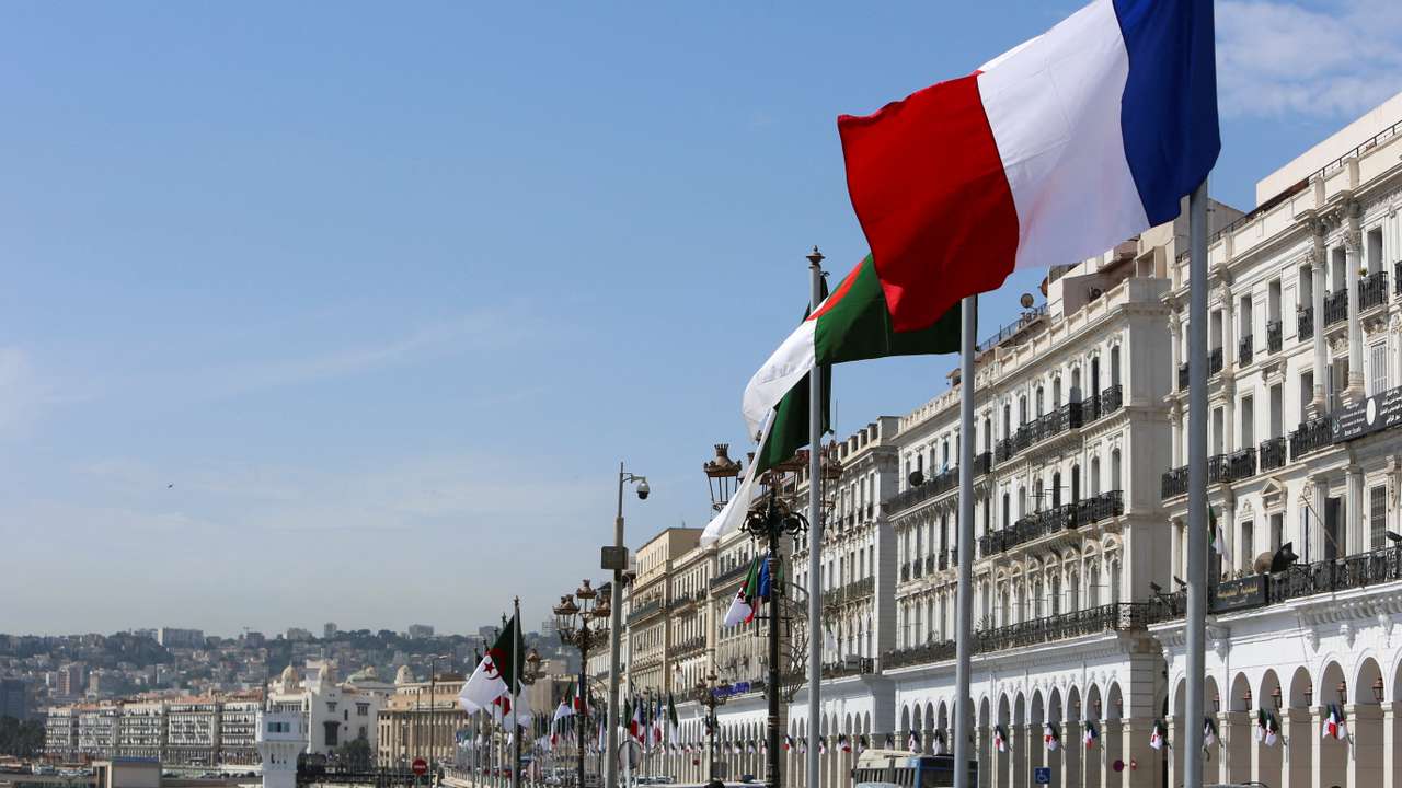 FILE PHOTO: Algerian and French flags flutter ahead of the arrival of French President Emmanuel Macron, in Algiers