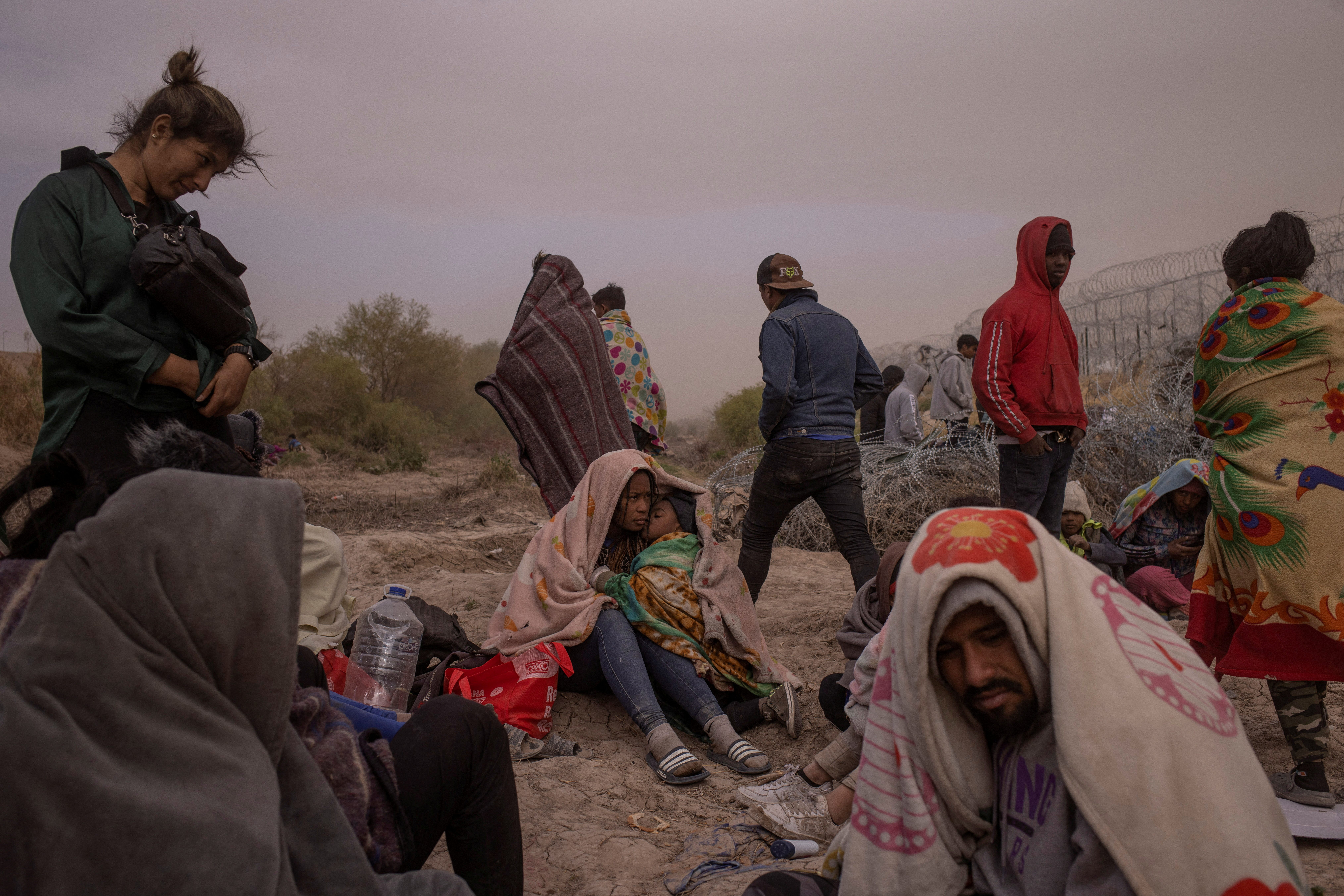 FILE PHOTO: Migrants endure wind and dust storm along bank of the Rio Grande river in El Paso