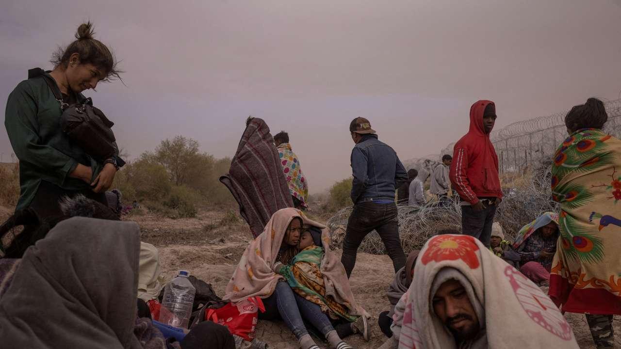 FILE PHOTO: Migrants endure wind and dust storm along bank of the Rio Grande river in El Paso