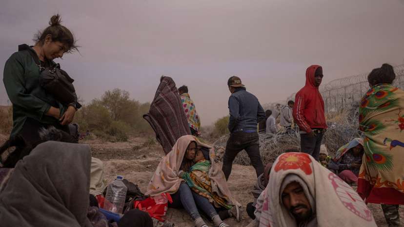 FILE PHOTO: Migrants endure wind and dust storm along bank of the Rio Grande river in El Paso