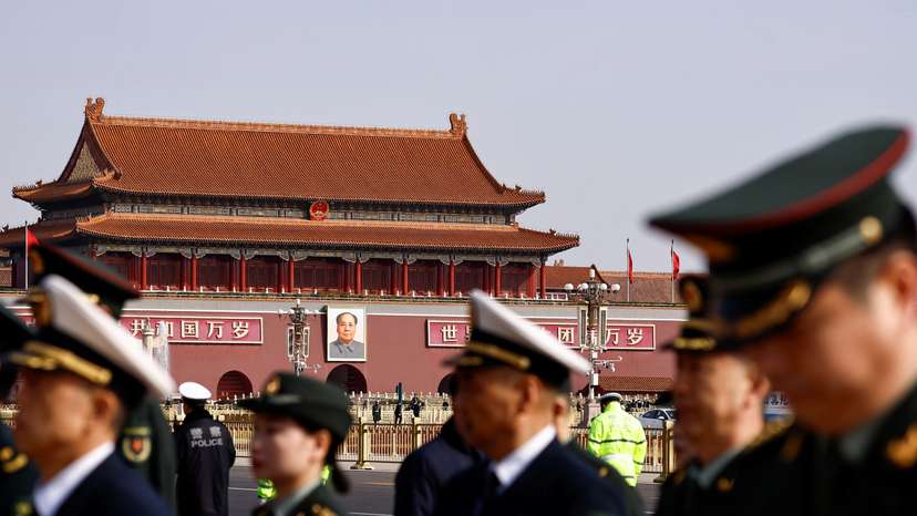 Military delegates walk past Tiananmen Square a day before the National People's Congress (NPC) meeting opens, in Beijing