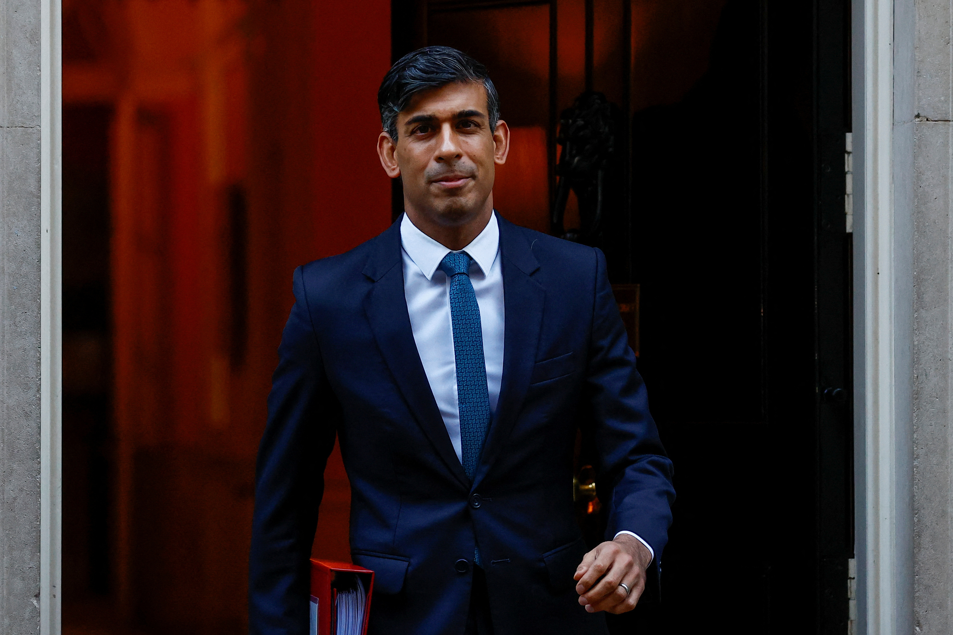Britain's PM Sunak walks outside 10 Downing Street ahead of PMQs, in London