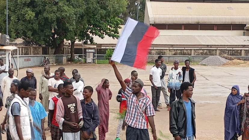 Demonstrators hold Russian flag as Nigerians continue to protest against economic hardship, in Kaduna state