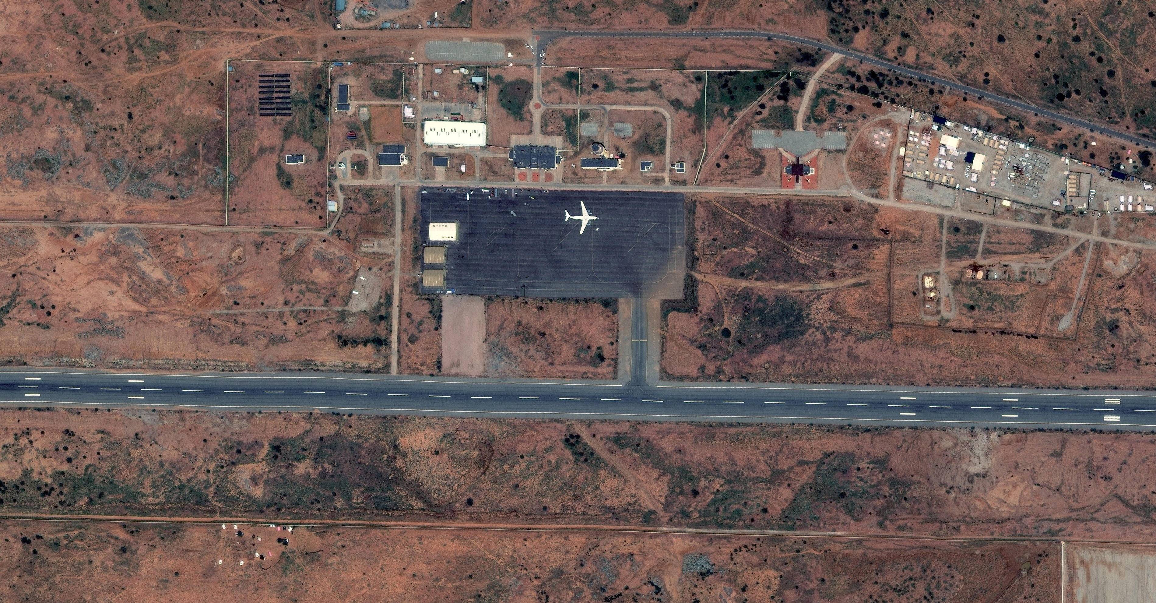The satellite image shows IL-76 cargo plane parked on the tarmac at Amdjarass International Airport, Ouadi Koudjinli
