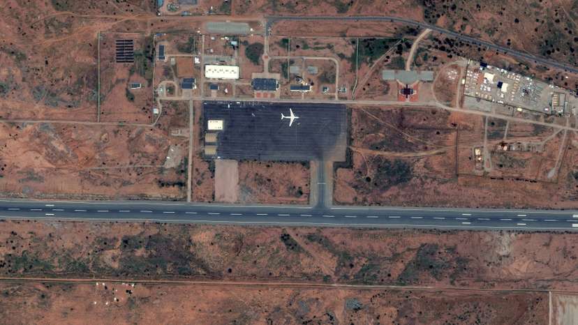 The satellite image shows IL-76 cargo plane parked on the tarmac at Amdjarass International Airport, Ouadi Koudjinli