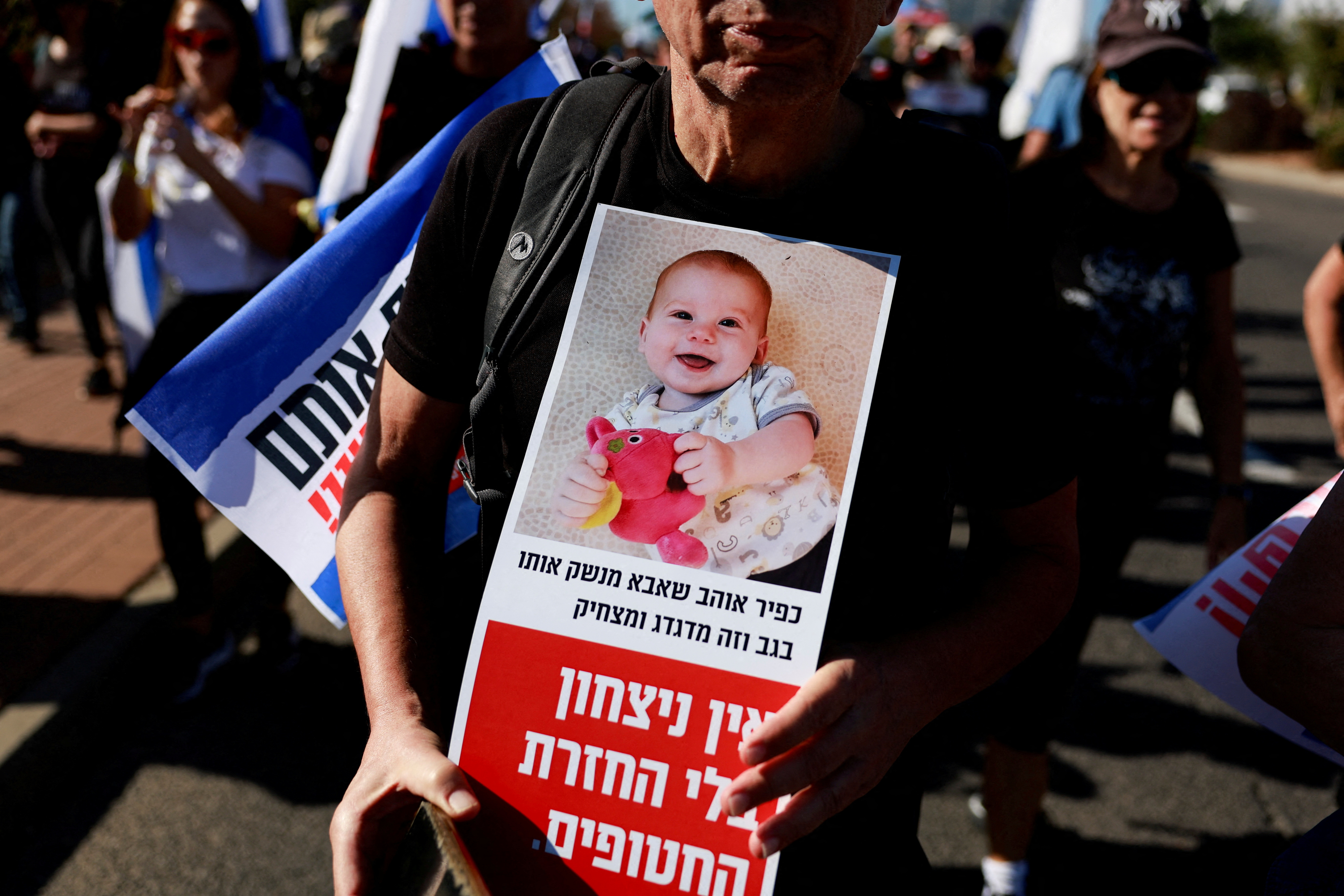 Family members, friends and supporters of Israeli hostages, take part in march at the outskirts of Tel Aviv