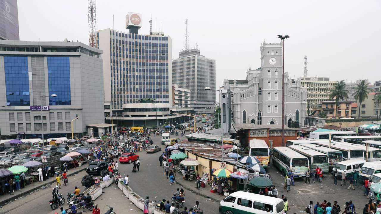 People move on a street of Marina in Victoria Island
