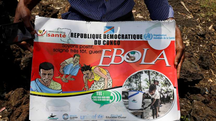Congolese volunteer Ferdinand Tangenyi displays a flip book he uses to inform people about the Ebola virus, in Goma