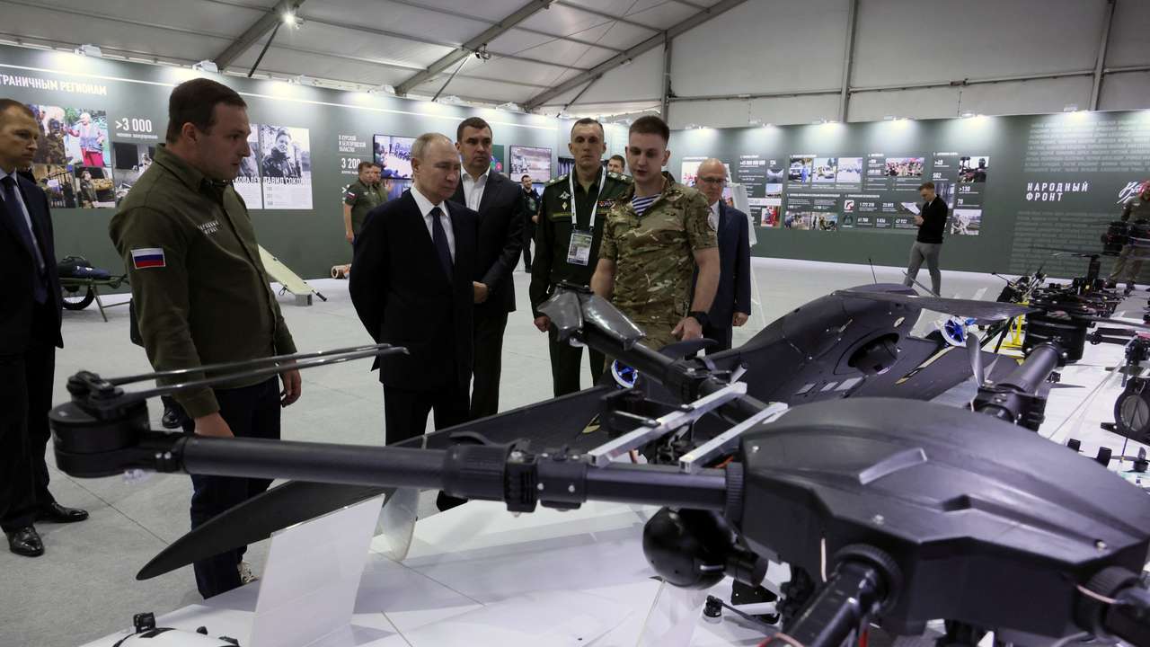Russian President Vladimir Putin tours a military exhibition in Moscow